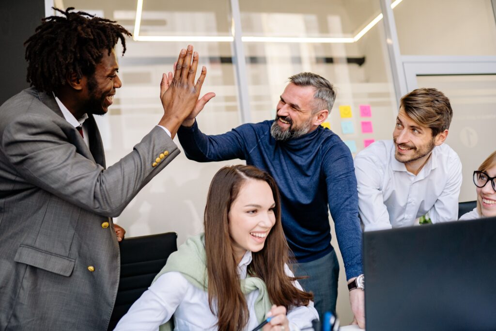 Employees collaborating in a positive workplace environment that promotes engagement, teamwork, and professional growth
